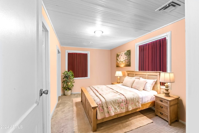 bedroom with light colored carpet and visible vents