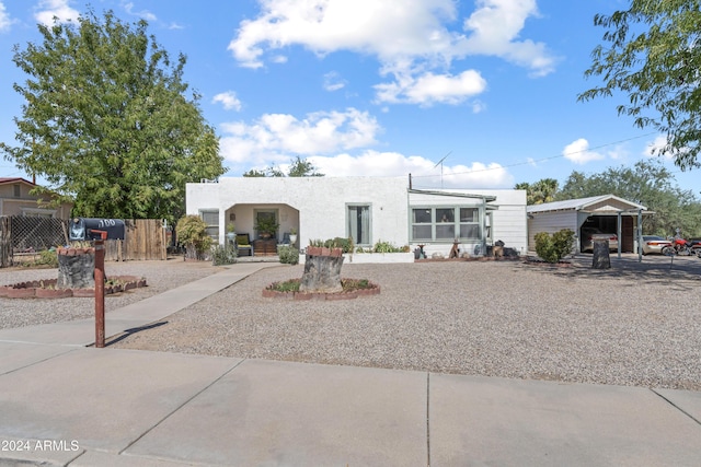 view of front of house featuring fence and stucco siding