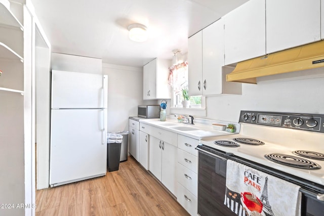 kitchen featuring range with electric cooktop, stainless steel microwave, freestanding refrigerator, under cabinet range hood, and a sink