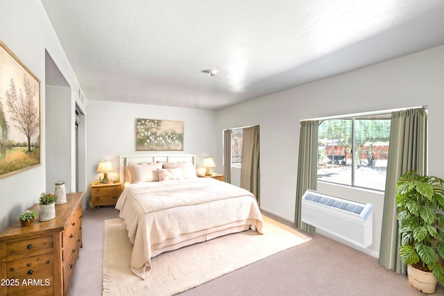 carpeted bedroom with a wall mounted air conditioner