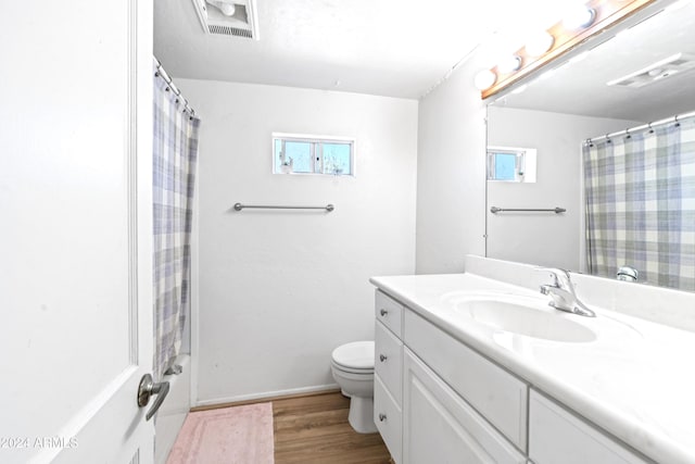 full bathroom featuring visible vents, vanity, wood finished floors, and toilet