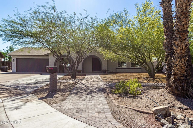 3061 W Betty Elyse Ln, Phoenix, AZ 85053 - view of front of house featuring brick siding, concrete driveway, and an attached garage