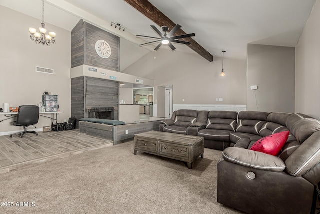 3061 W Betty Elyse Ln, Phoenix, AZ 85053 - living area with carpet floors, beam ceiling, a ceiling fan, a fireplace, and high vaulted ceiling