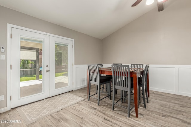 3061 W Betty Elyse Ln, Phoenix, AZ 85053 - dining area featuring a ceiling fan, french doors, vaulted ceiling, a decorative wall, and wood finished floors