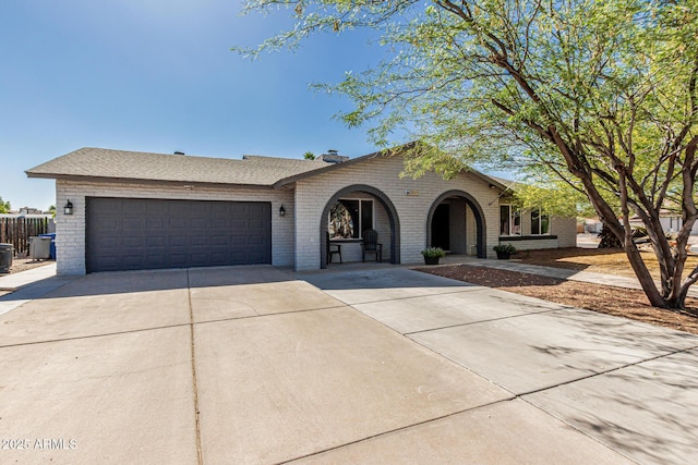 3061 W Betty Elyse Ln, Phoenix, AZ 85053 - view of front of property with brick siding, concrete driveway, and a garage