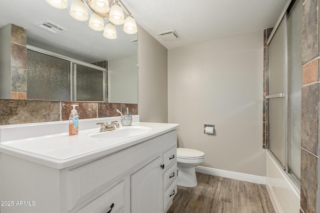 3061 W Betty Elyse Ln, Phoenix, AZ 85053 - bathroom featuring vanity, wood finished floors, combined bath / shower with glass door, and a chandelier