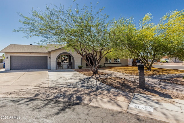 3061 W Betty Elyse Ln, Phoenix, AZ 85053 - view of front of property featuring concrete driveway, a garage, and brick siding
