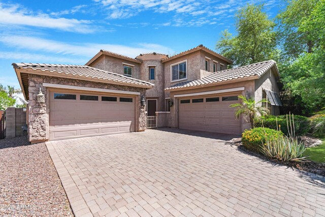 2856 E Desert Broom Pl, Chandler, AZ 85286 - mediterranean / spanish-style house with an attached garage, decorative driveway, stucco siding, and a tile roof