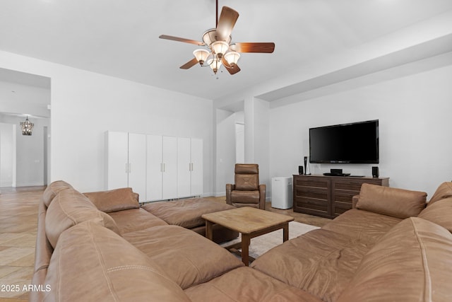 living room with ceiling fan with notable chandelier