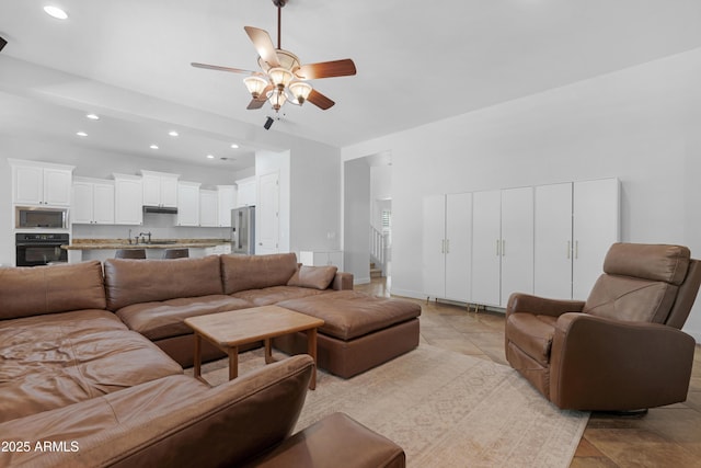 living room with stairway, ceiling fan, and recessed lighting