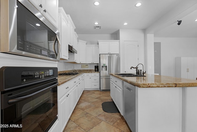 kitchen featuring visible vents, light stone countertops, white cabinetry, a sink, and stainless steel appliances