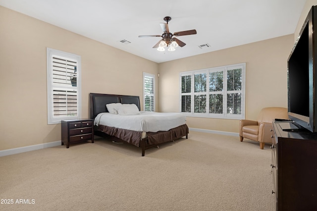 bedroom featuring visible vents, baseboards, and light carpet