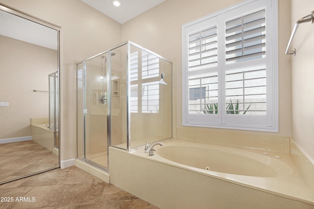 bathroom with plenty of natural light, tile patterned flooring, a bath, and a shower stall