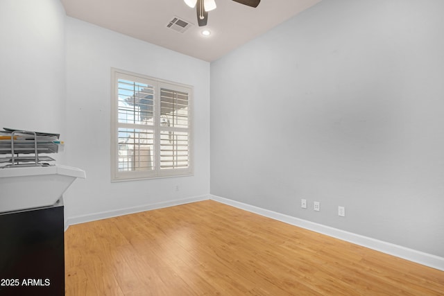 unfurnished dining area featuring visible vents, baseboards, ceiling fan, and wood finished floors