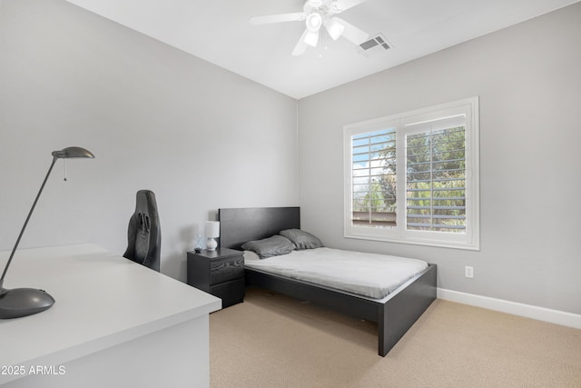 bedroom with a ceiling fan, baseboards, visible vents, and light carpet