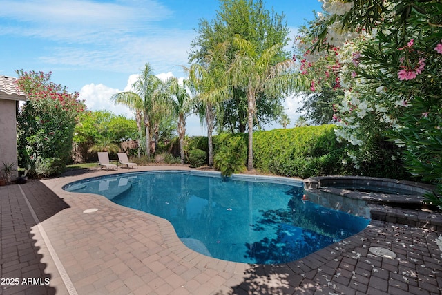 view of swimming pool featuring a patio and a pool with connected hot tub