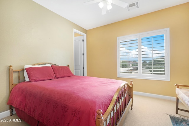 carpeted bedroom with a ceiling fan, baseboards, and visible vents