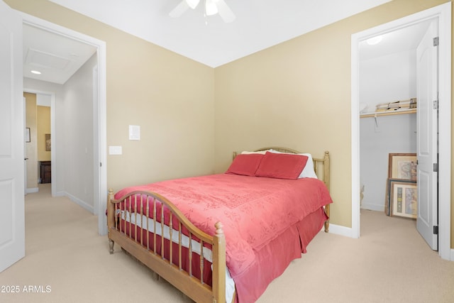 bedroom featuring baseboards, attic access, carpet, and a spacious closet