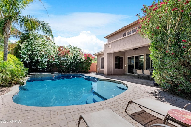 pool with a ceiling fan and a patio area