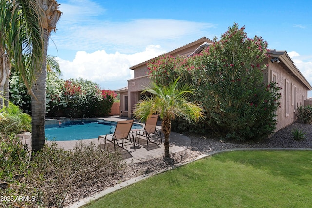 view of swimming pool featuring a fenced in pool, a patio area, and a yard
