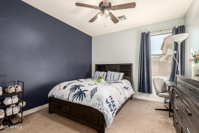 carpeted bedroom with baseboards, visible vents, and a ceiling fan