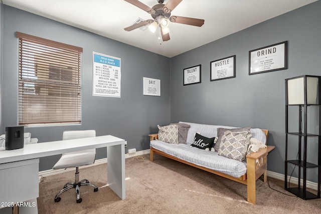 carpeted home office with baseboards and a ceiling fan