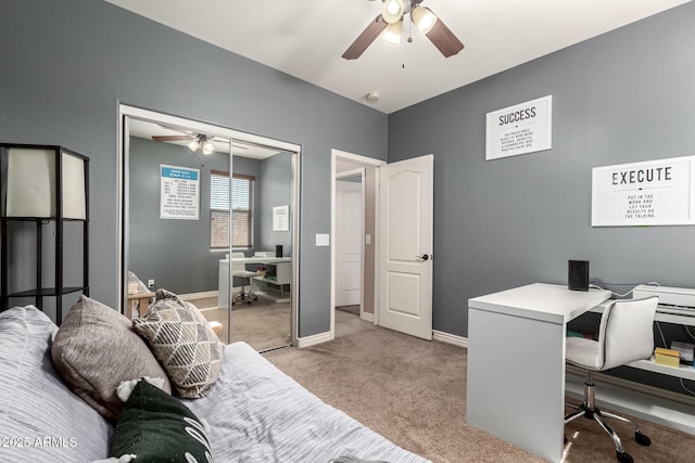 home office featuring baseboards, ceiling fan, and carpet