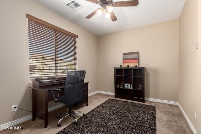 office space featuring a ceiling fan, carpet floors, baseboards, and visible vents