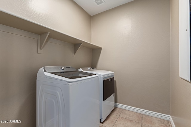 laundry room with laundry area, baseboards, light tile patterned floors, independent washer and dryer, and visible vents