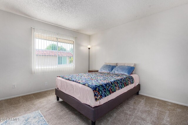 bedroom with carpet flooring and a textured ceiling