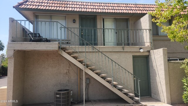 back of property featuring central AC unit