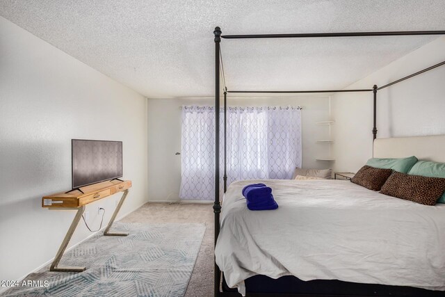 carpeted bedroom featuring a textured ceiling