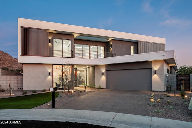 modern home with a balcony and a garage