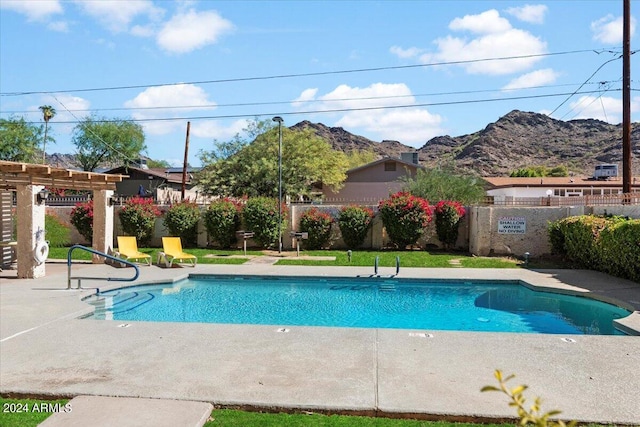 view of pool featuring a mountain view, a patio area, and a pergola