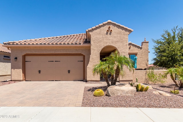 mediterranean / spanish home featuring a garage