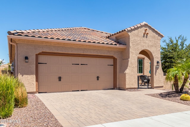 mediterranean / spanish-style home with a garage