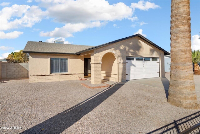 ranch-style home featuring a garage