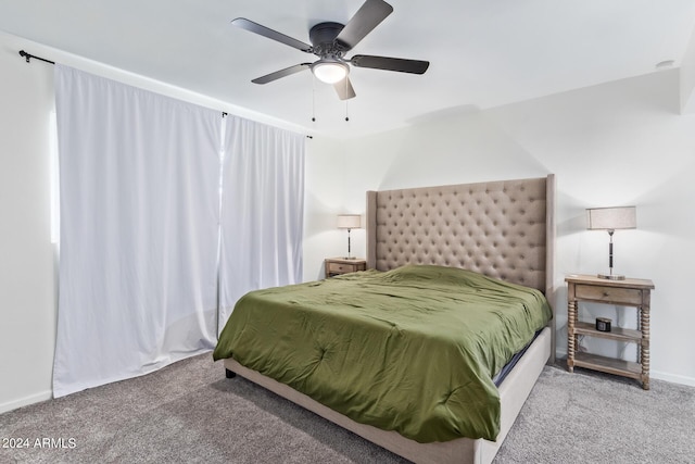 carpeted bedroom with baseboards and a ceiling fan