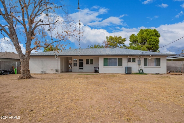 view of front of property with fence, central AC, and a patio area