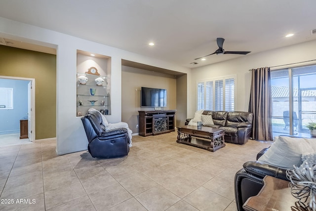 living room with ceiling fan, light tile patterned flooring, and built in features