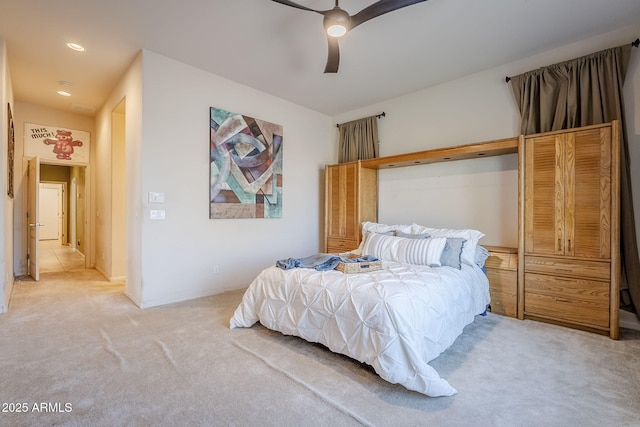 bedroom with ceiling fan and light colored carpet