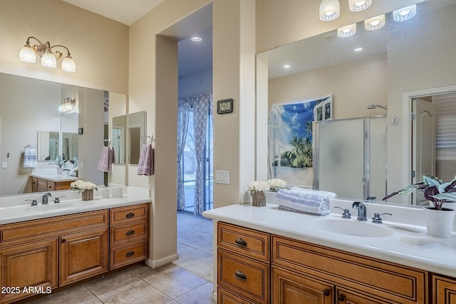 bathroom featuring tile patterned floors, vanity, and a shower with shower door