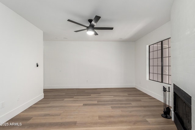 5230 E Brown Rd Unit 114, Mesa, AZ 85205 - spare room with a fireplace, ceiling fan, heating unit, and wood finished floors