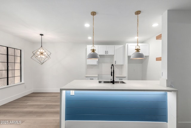 5230 E Brown Rd Unit 114, Mesa, AZ 85205 - kitchen with white cabinets, light wood-style floors, hanging light fixtures, recessed lighting, and light countertops