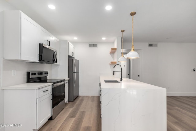 5230 E Brown Rd Unit 114, Mesa, AZ 85205 - kitchen featuring appliances with stainless steel finishes, light wood-type flooring, white cabinets, and recessed lighting