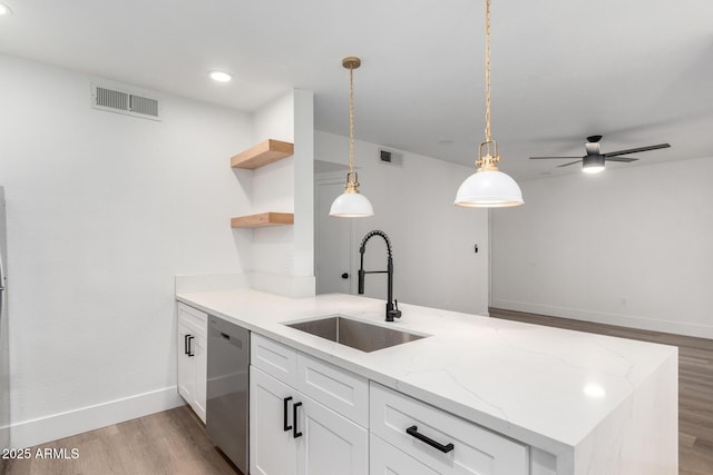 5230 E Brown Rd Unit 114, Mesa, AZ 85205 - kitchen with dishwasher, open shelves, light wood finished floors, white cabinets, and a peninsula