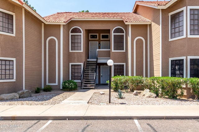 5230 E Brown Rd Unit 114, Mesa, AZ 85205 - property entrance with a tiled roof, stucco siding, and uncovered parking