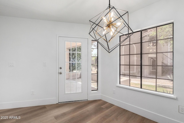 5230 E Brown Rd Unit 114, Mesa, AZ 85205 - unfurnished dining area with a chandelier and wood finished floors