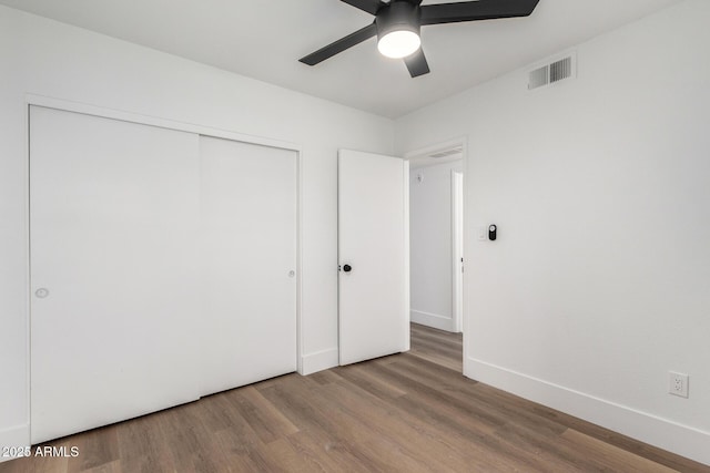 5230 E Brown Rd Unit 114, Mesa, AZ 85205 - unfurnished bedroom featuring wood finished floors, a closet, and ceiling fan