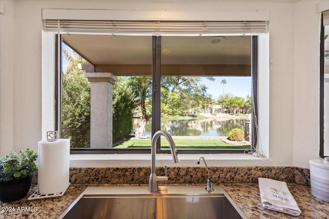 interior details featuring a water view and sink